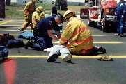 A Michigan
                  State Police officer bags the victim while a
                  firefighter does compressions.